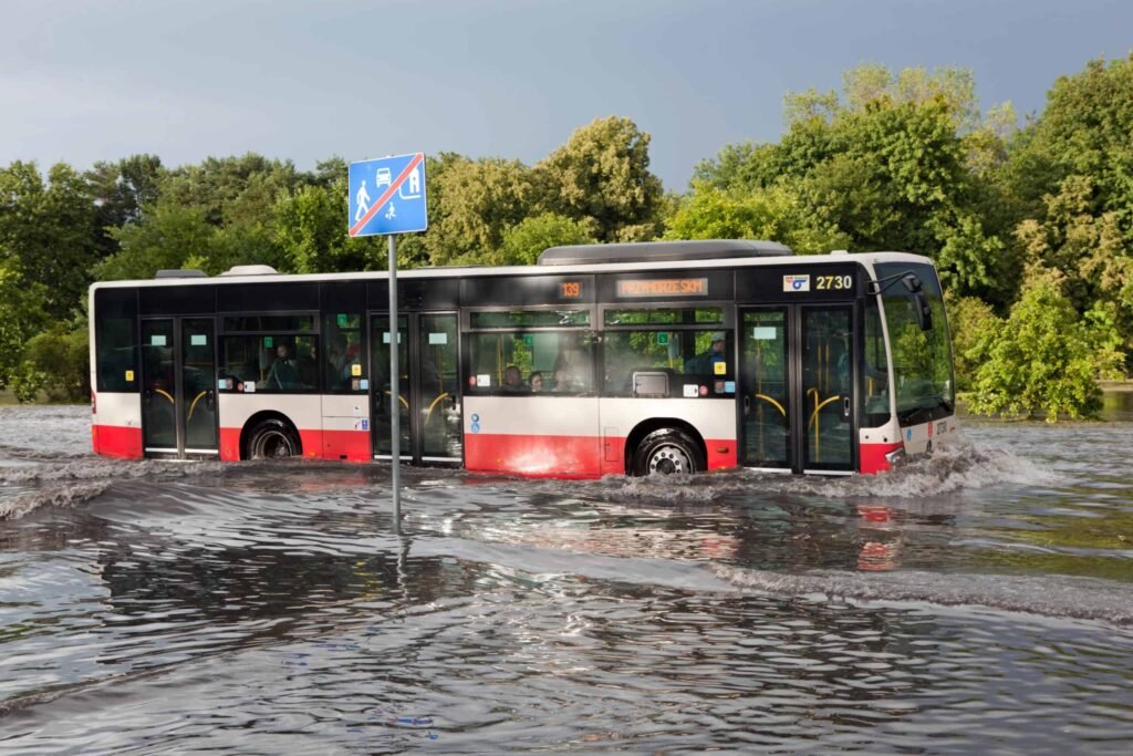 Bus driving through flooded roads. Image by Photocreo via Depositphotos.