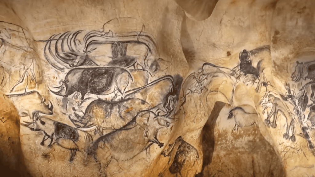 Cave wall covered in paintings.