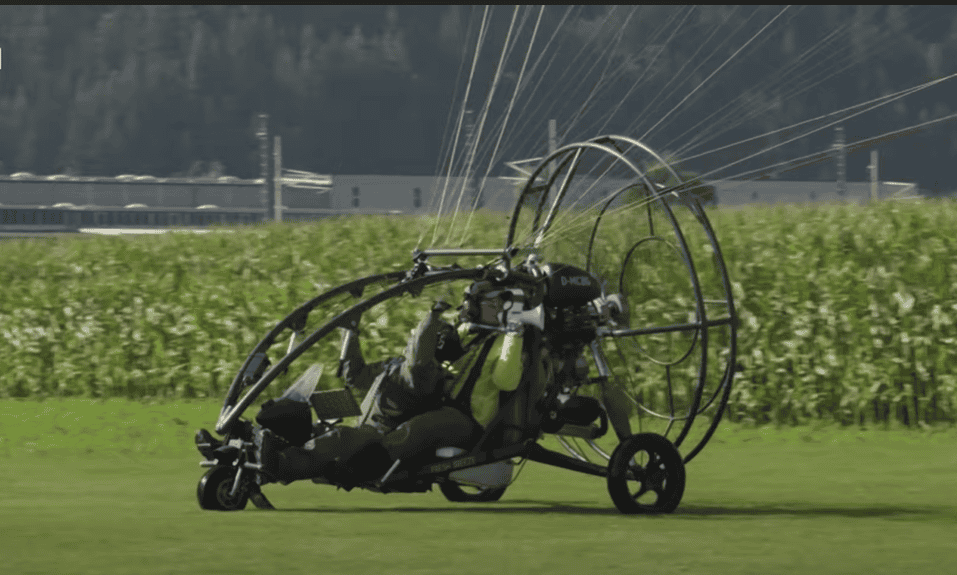 Scientists in a microlight aircraft.