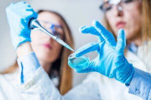 Life science research. Technicians using micro pipette