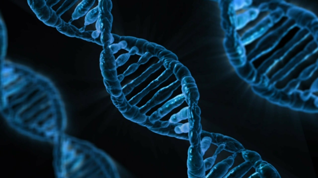 Blue DNA double helix structure on a dark background