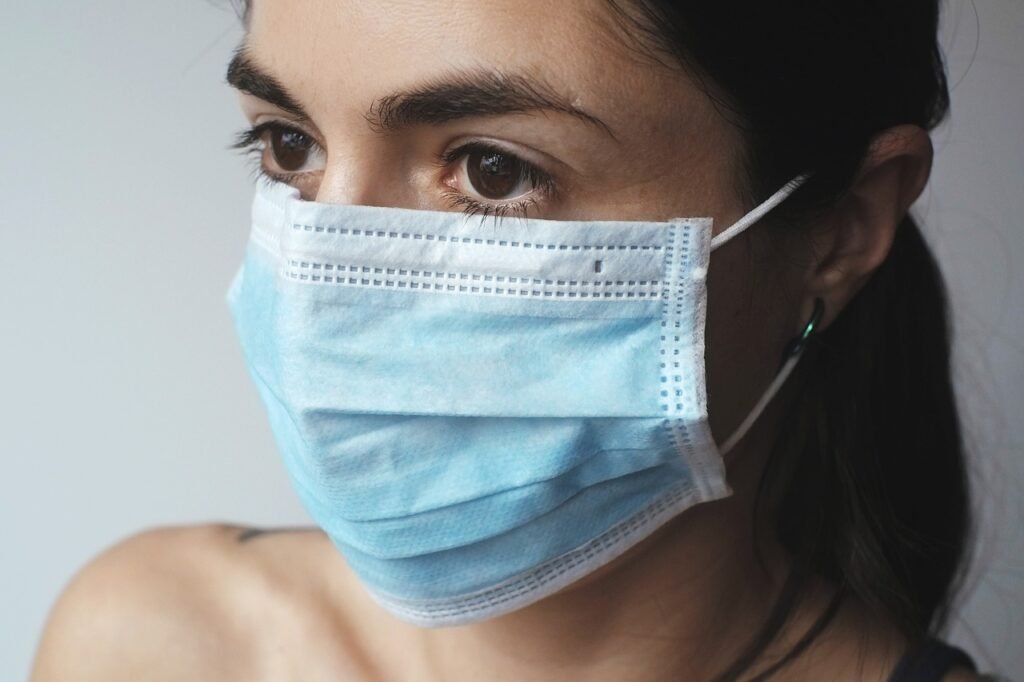 Woman wearing a blue surgical mask