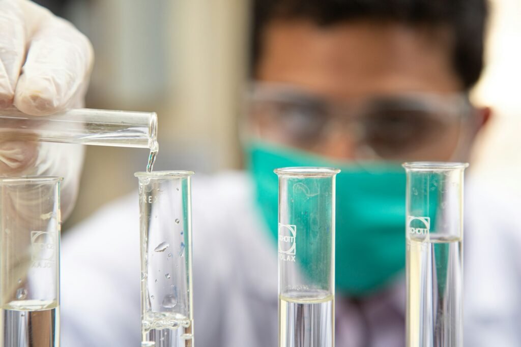 A scientist pouring liquid into test tubes.