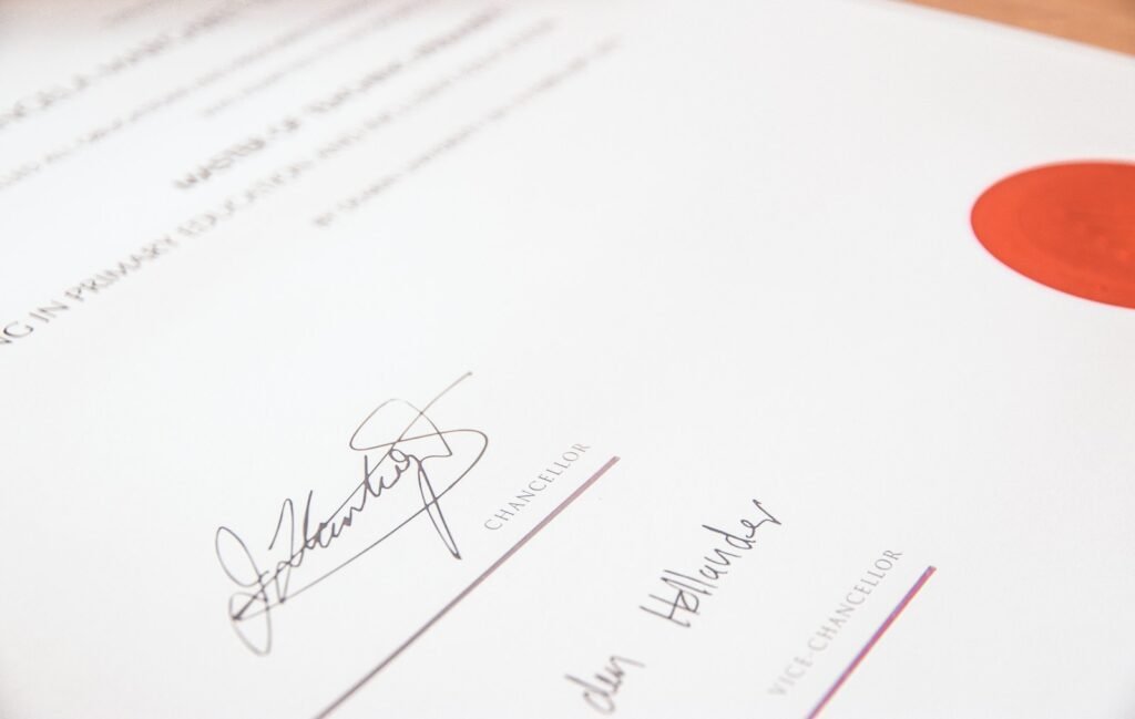 Close-up of a signed official document with a red seal, symbolizing authenticity and certification.