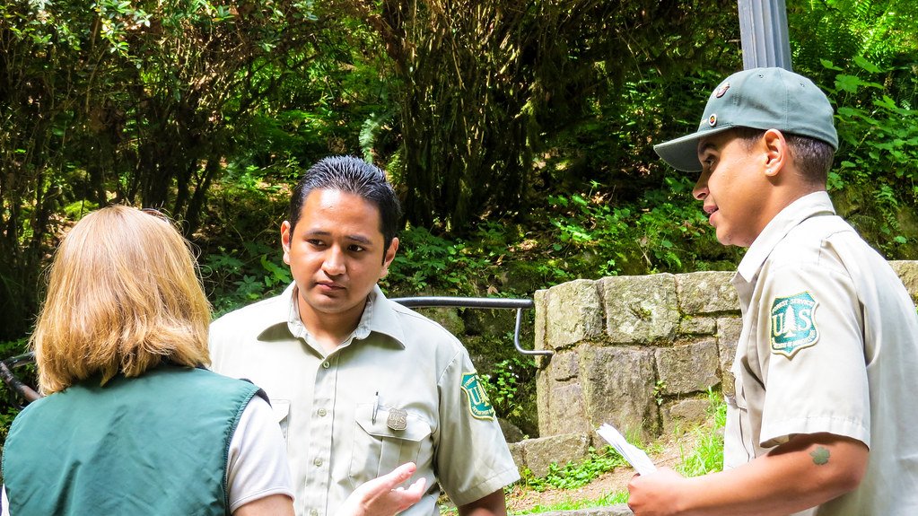 US Forest Service Field Rangers Talking with Woman at Multnomah Falls Viewing Area on the Columbia River Gorge National Scenic Area.