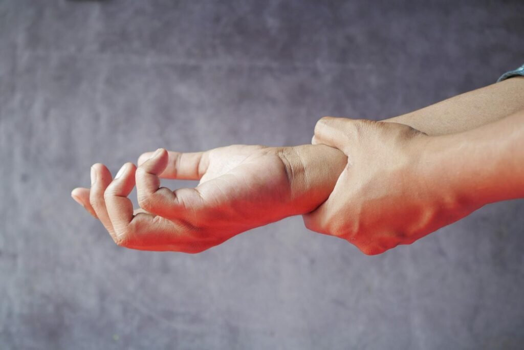 Close-up of hands, one grasping the other.
