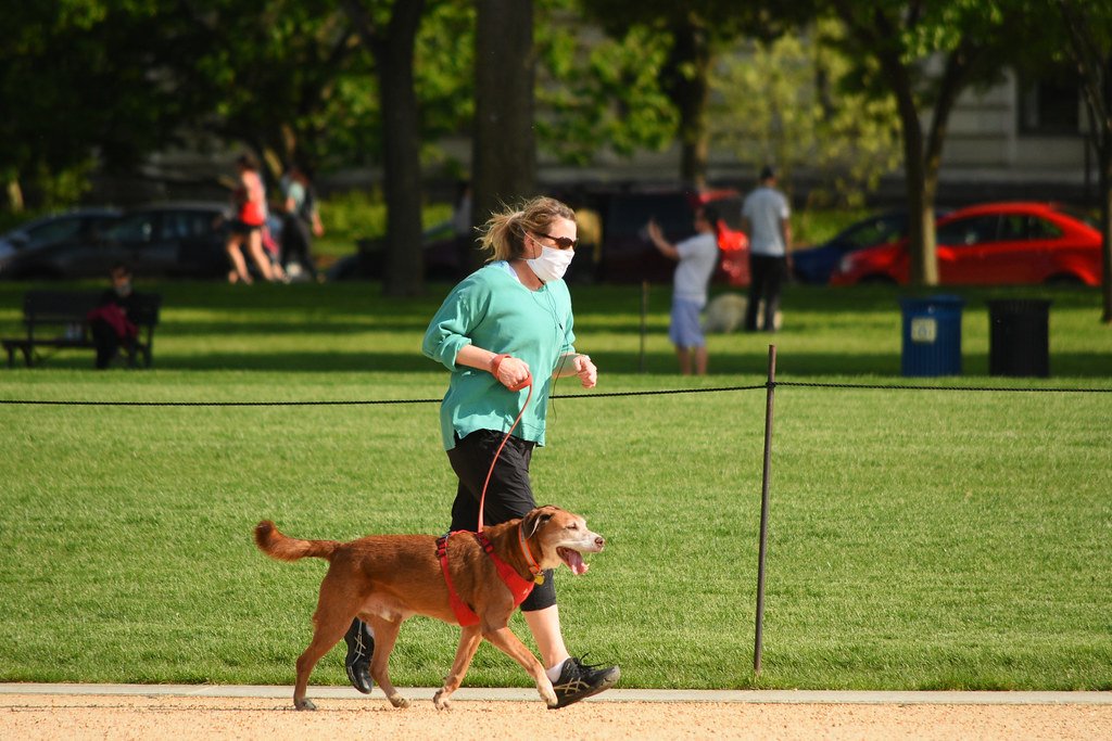 Woman running with dog