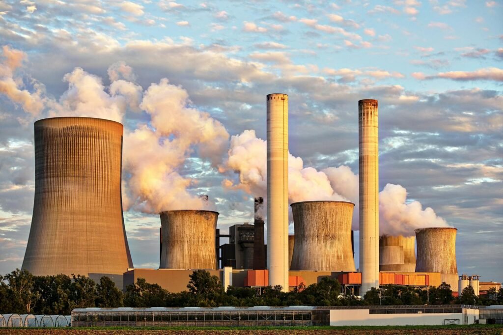 Power plant releasing smoke from tall chimneys.