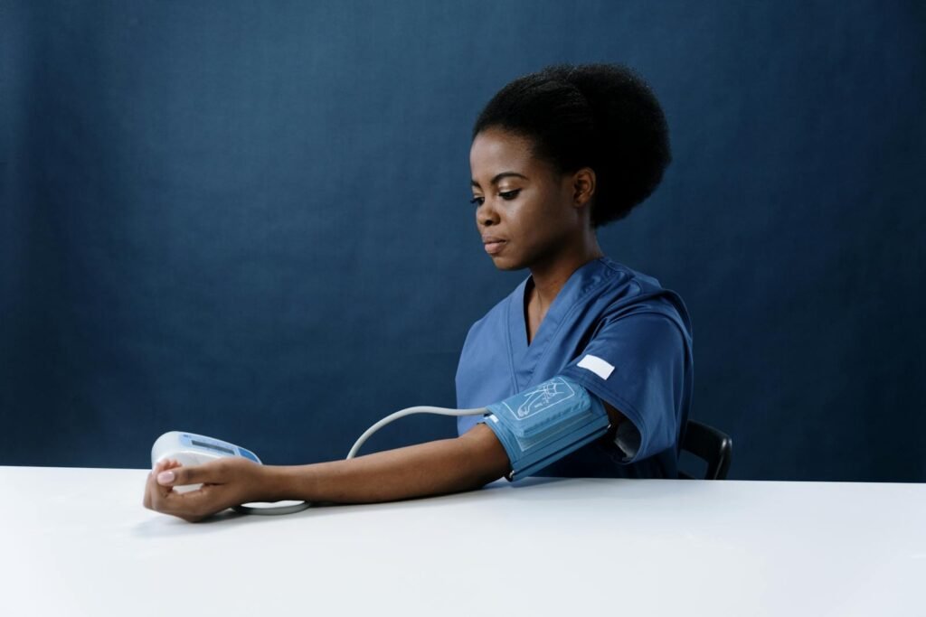 African American nurse measuring blood pressure.