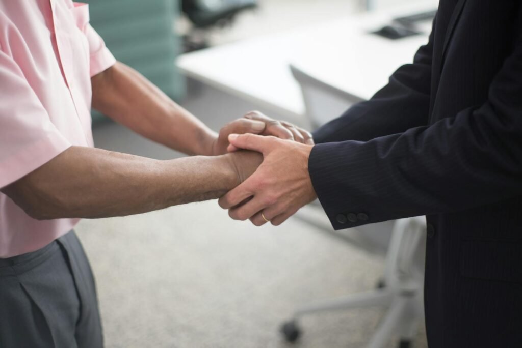 Two people shaking hands in a business setting