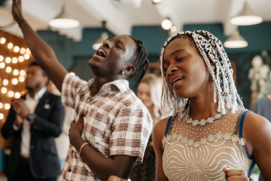 African American people joyfully singing in a lively church service, embodying spirituality.