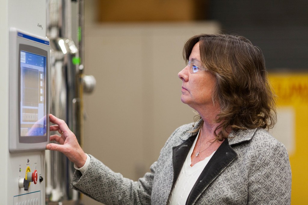 Karen McDonald looking at genetic engineered cells. 