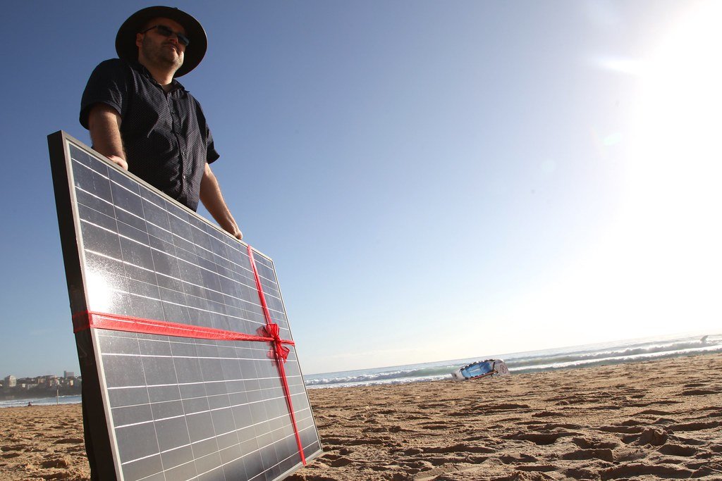Solar panel gift on Manly beach as Common Grace ask PM Tony Abbott to #acceptthegift of solar for Kirribilli House.