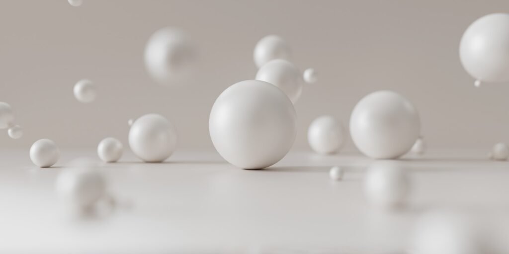 A group of white balls bouncing on the floor.