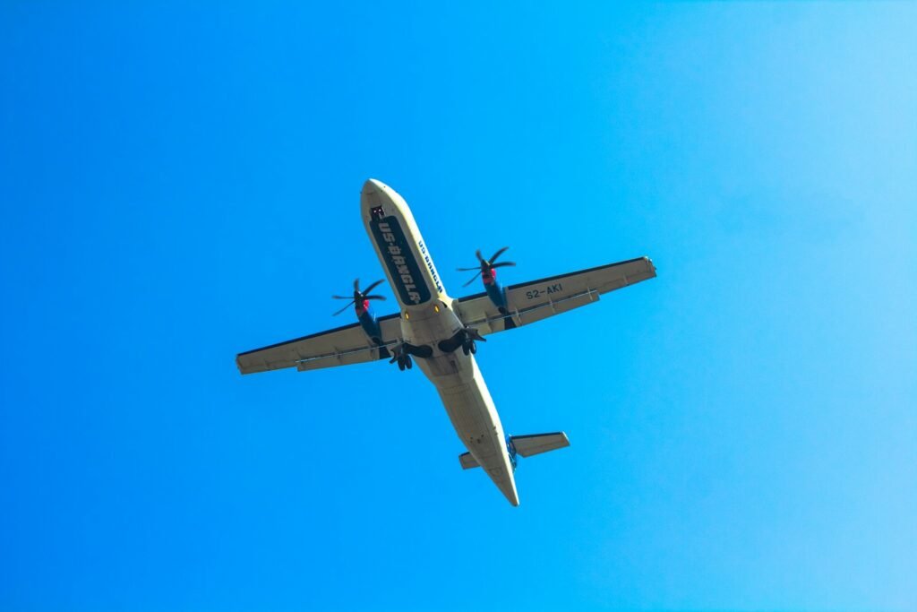 Passenger jet flying through a blue sky.