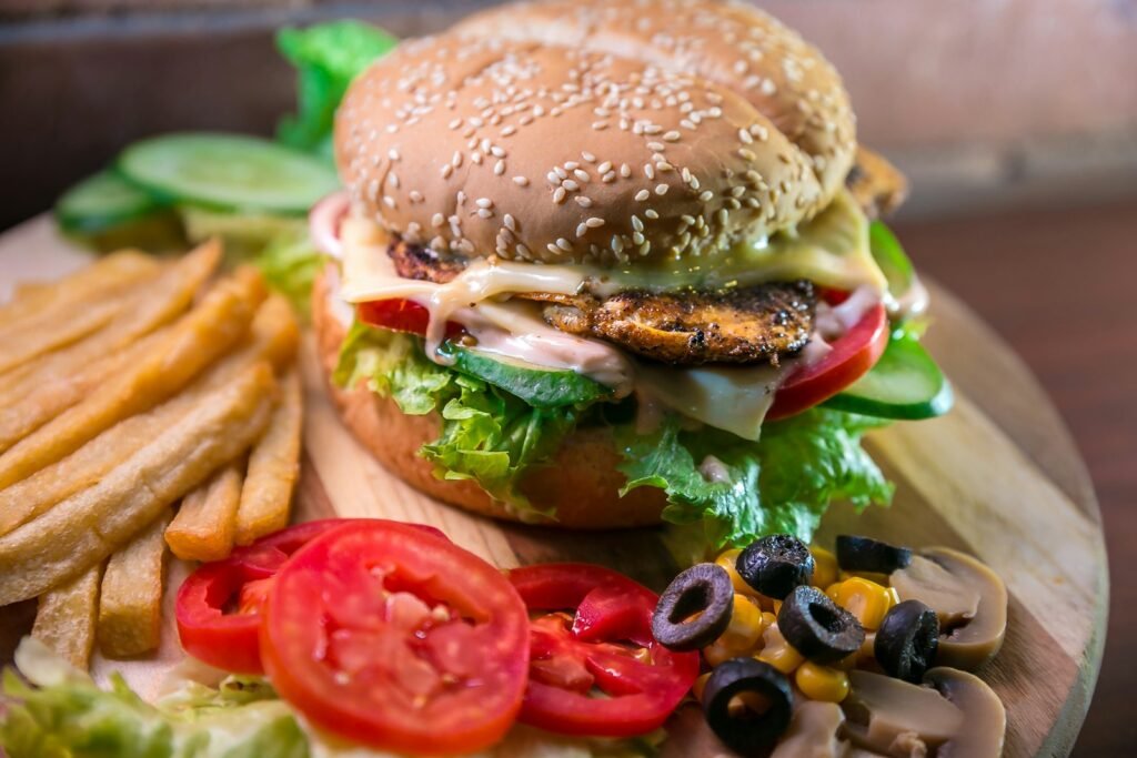 Burgers and fries on a wooden board.