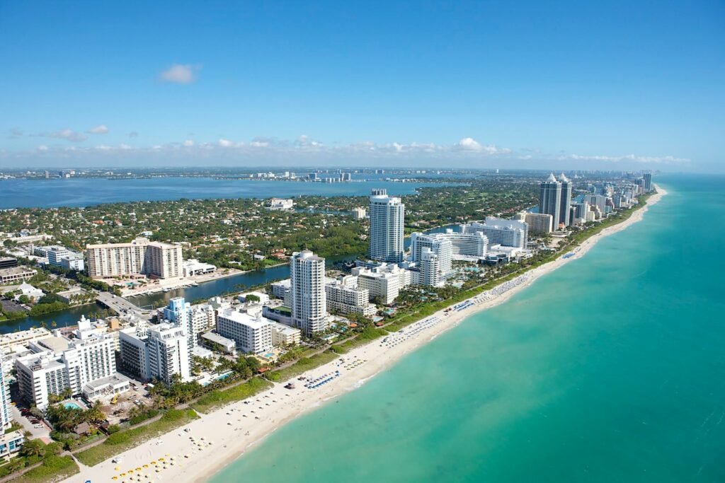Aerial view of Miami buildings near body of water during daytime.
