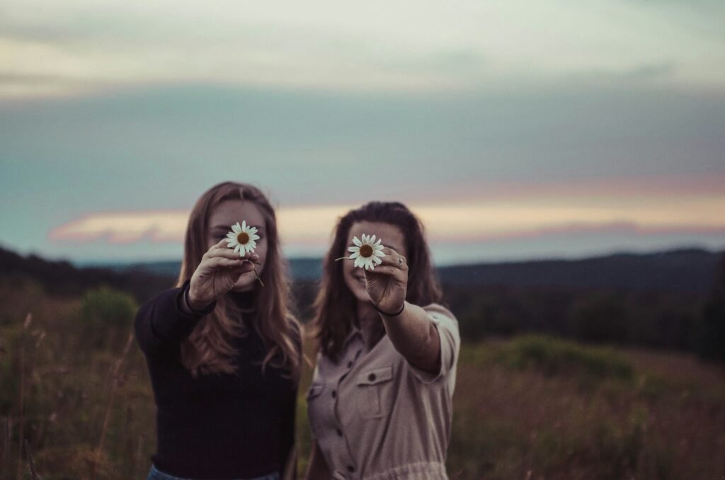 Young women holding flowers.