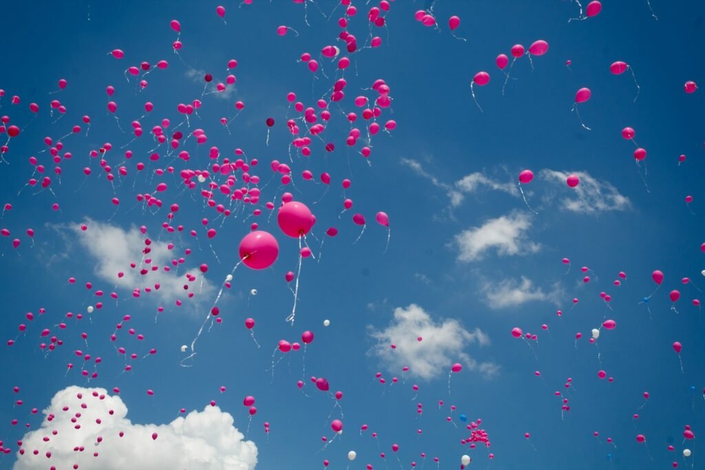 Many pink balloons on air to celebrate cancer cure.