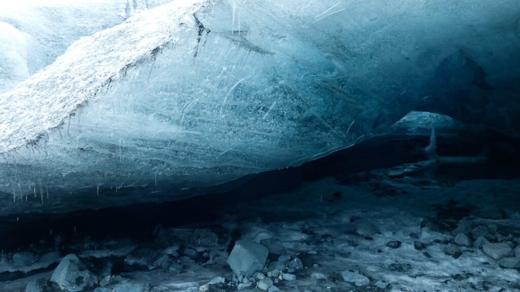 Explore the mesmerizing interior of an ice cave with stunning blue hues.