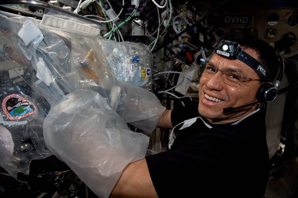 Astronaut Frank Rubio works on a 3D bioprinter.