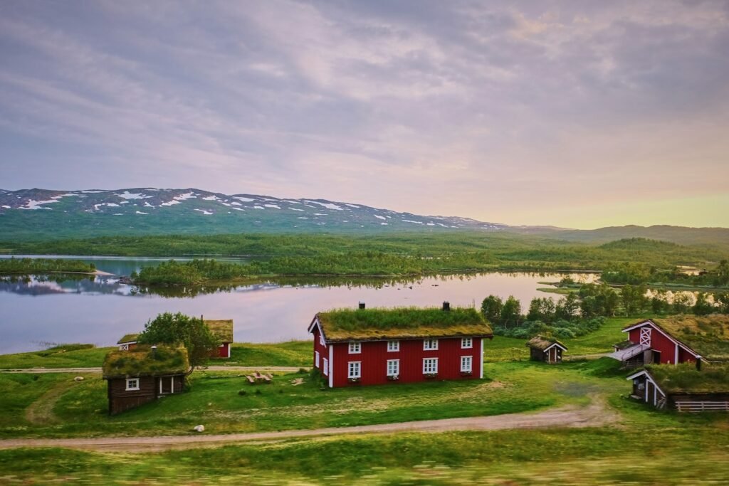 Landscape of a farmhouse situated near a body of water.