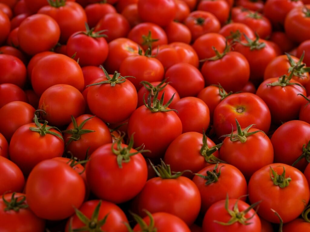 Close-up image of fresh, ripe tomatoes providing a vibrant pattern and healthy, organic feel.