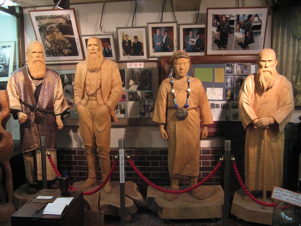 A group of wooden Ainu people.