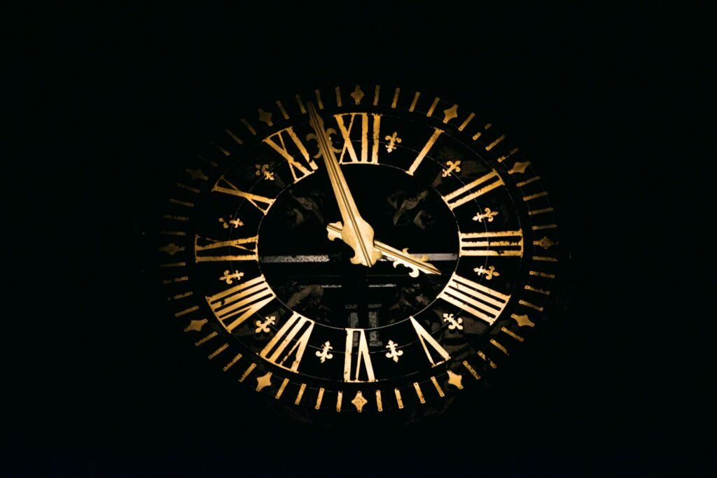 Round black and brown analog clock.