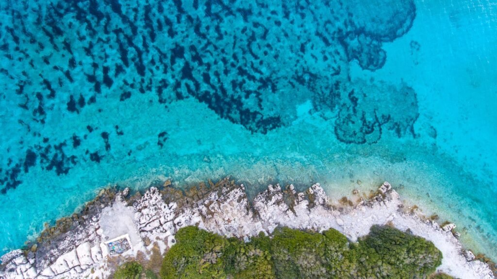 A breathtaking aerial view of the turquoise waters and rocky coastline in Jezerane, Croatia.