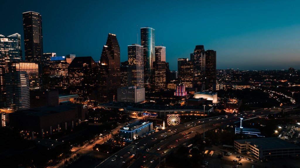 Stunning aerial view of downtown Houston's illuminated skyscrapers at dusk.
