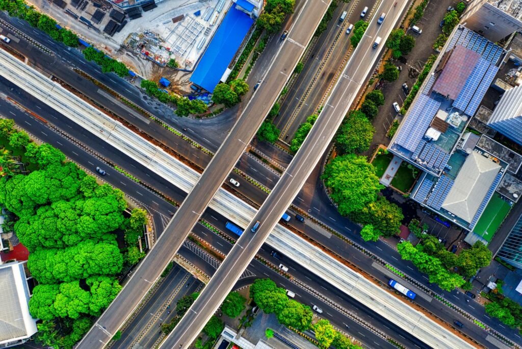 A vibrant aerial view of South Jakarta's highways and greenery, showcasing urban development and infrastructure.