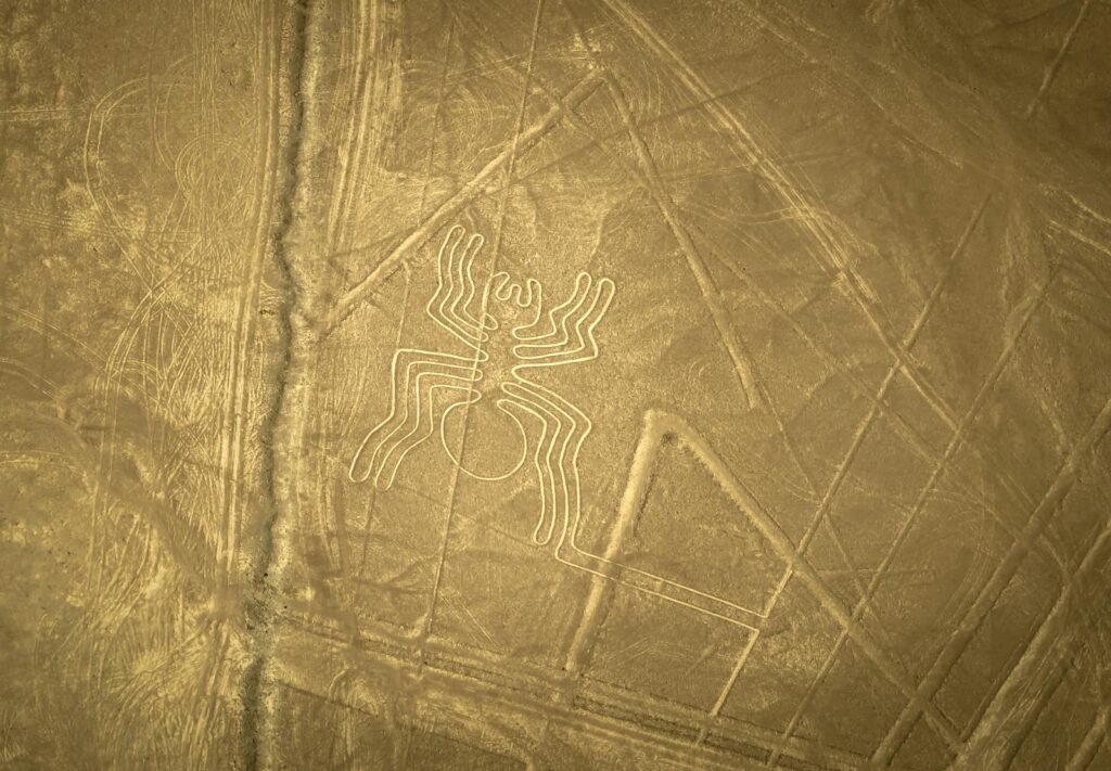 Stunning aerial shot of the Nazca Lines spider geoglyph in the Peruvian desert.