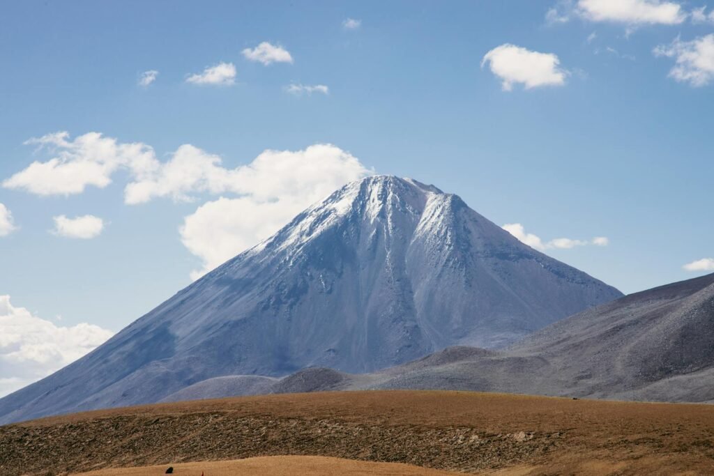 Scenic view of a snow-capped mountain under a clear blue sky in Atacama desert.