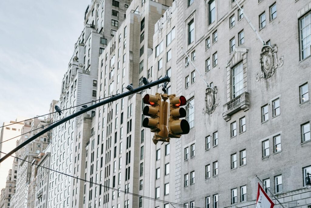 View of a traffic light with historic buildings in the background, showcasing urban architecture.