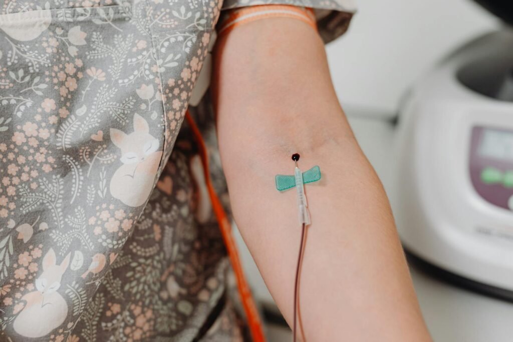 Close-up shot of an intravenous catheter inserted in a patient's arm for medical treatment.