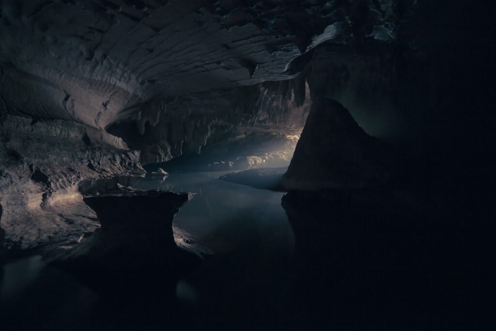 Cave interior with body of water.