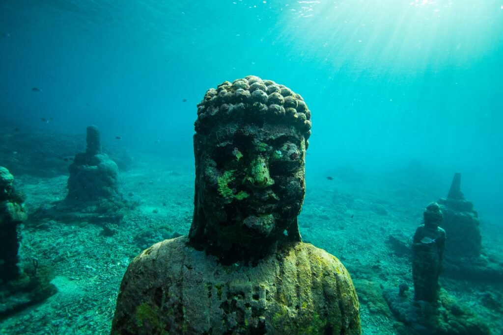 Concrete statue deep in water.