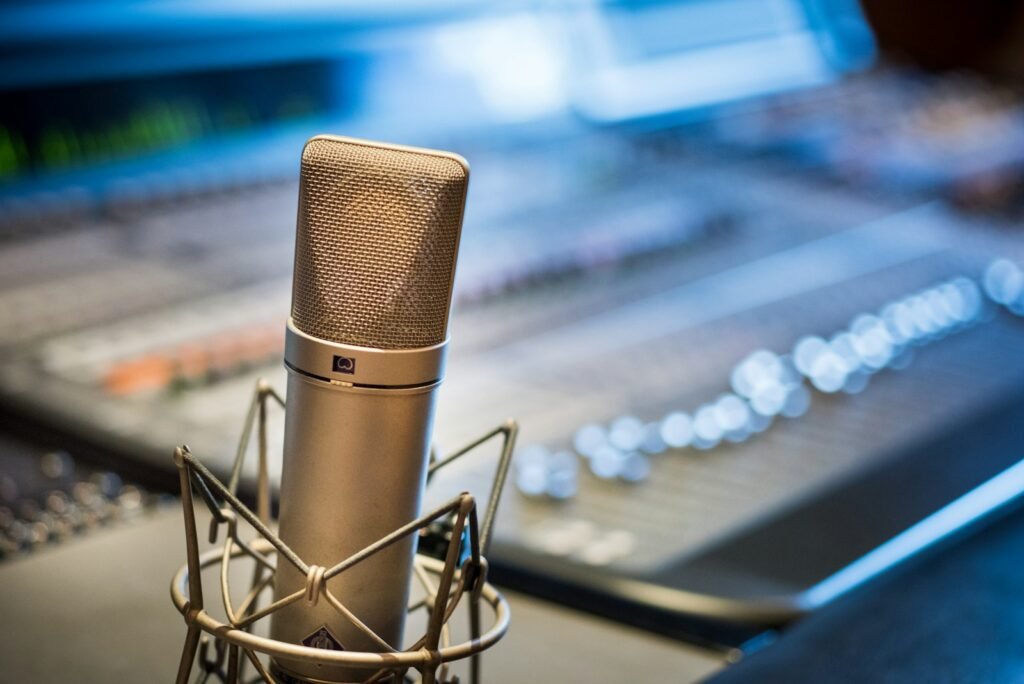 Silver microphone near audio mixer.