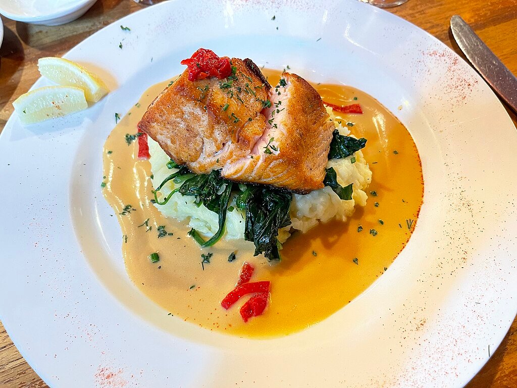 Salmon with mashed potatoes, spinach and lobster sauce. 