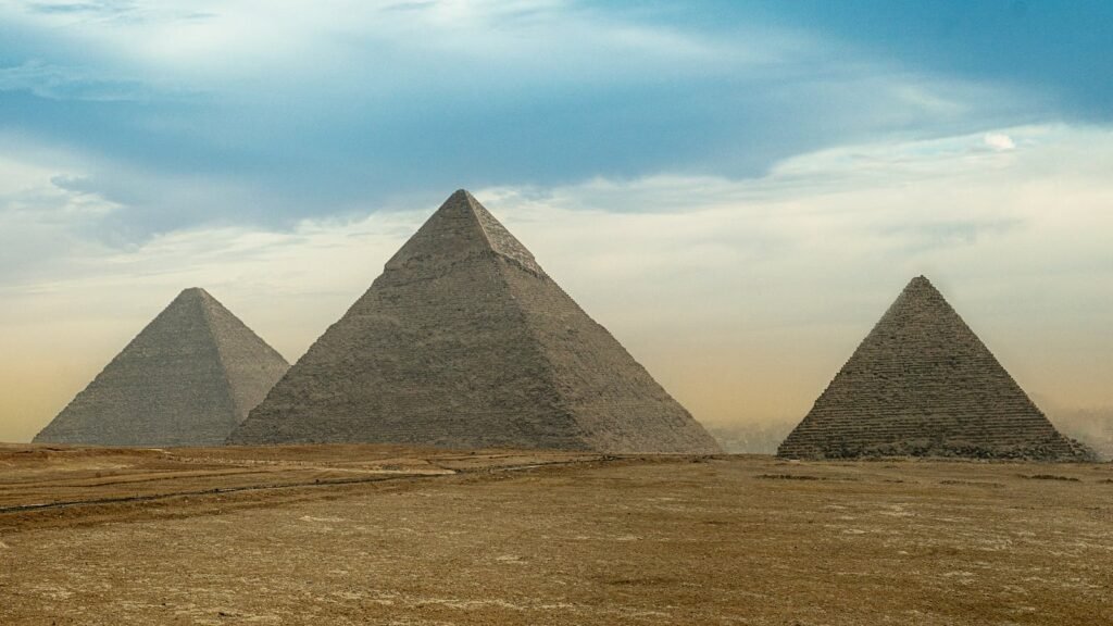 Captivating sight of the iconic Pyramids of Giza under a vast sky in Egypt.