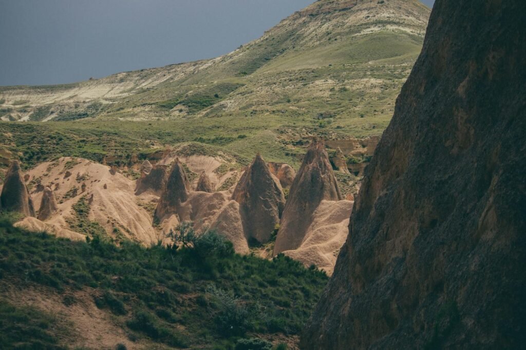 Captivating view of Cappadocia's unique rock formations under a moody sky, showcasing natural beauty.
