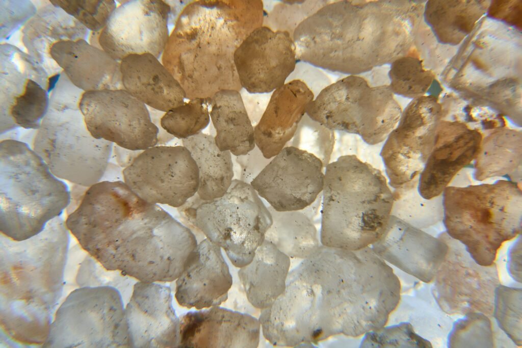 a group of rocks sitting on top of a sandy beach
