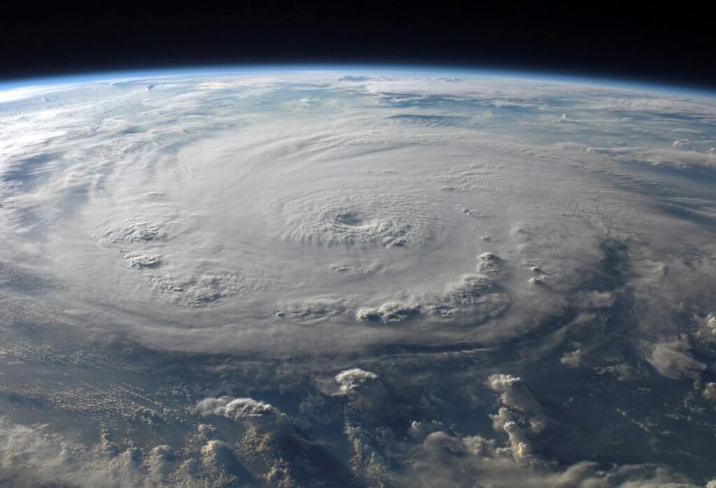 A stunning aerial view of Earth with a massive swirling hurricane, highlighting meteorological beauty.