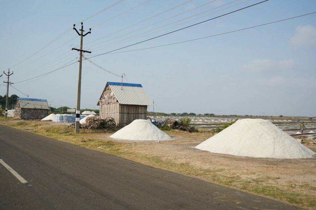 A row of salt domes next to a road.