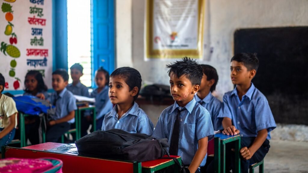 Group of young children sitting in a classroom.