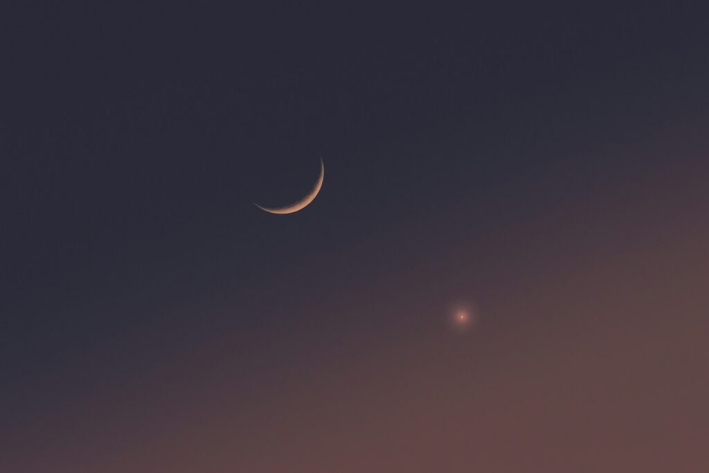 Two crescents are seen in the night sky.