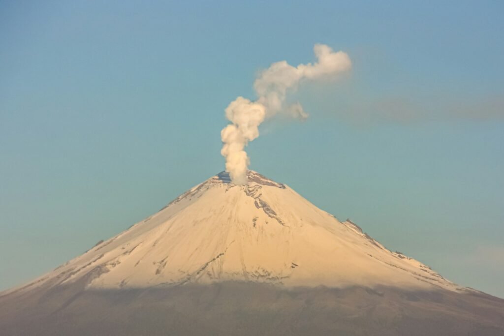 a mountain with a plume of smoke coming out of it