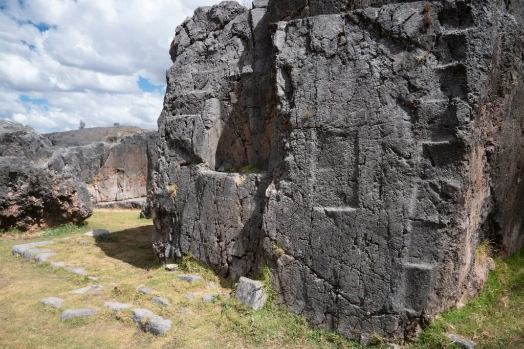 a large rock formation in the middle of a field