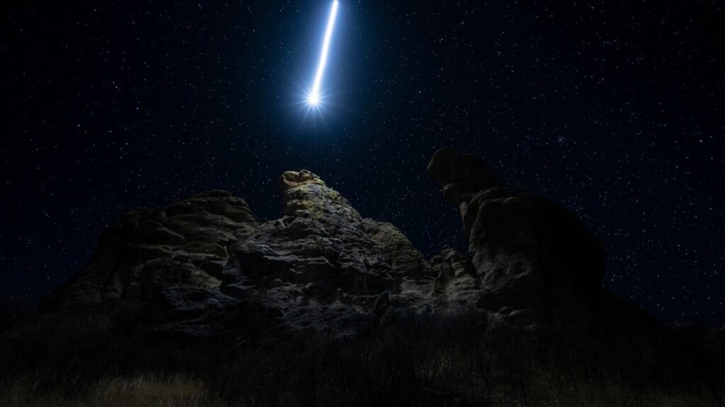 Majestic comet and starry night sky above dramatic rock formations in Durango, Mexico.